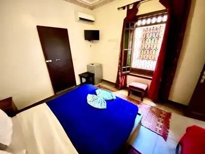 a room with a blue table and a window at Riad Jibraile in Marrakech