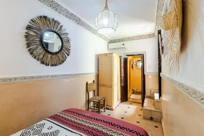 a room with a bed and a mirror on the wall at Riad Davina in Marrakech