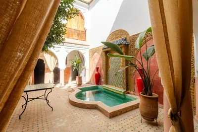 a courtyard with a pool in a building at Riad Davina in Marrakech