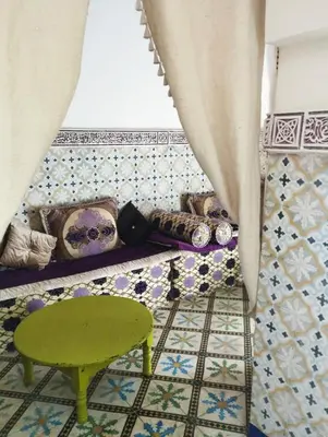 a room with a green stool and a tiled floor at Riad Bouchouari 33 in Marrakech