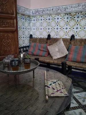 a living room with a couch and a table at Riad Bouchouari 33 in Marrakech