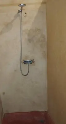 a shower in a bathroom with a hose on the wall at Riad Bouchouari 33 in Marrakech