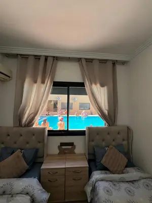 a bedroom with a view of a swimming pool at Guéliz l’hivernage nour5 in Marrakech