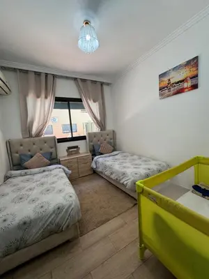 a bedroom with two beds and a window at Guéliz l’hivernage nour5 in Marrakech