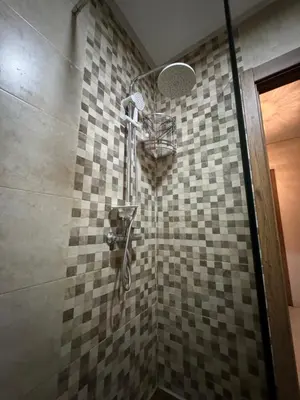 a shower in a bathroom with a tiled wall at Guéliz l’hivernage nour5 in Marrakech