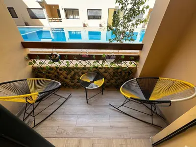 two chairs and a table on a balcony at Appartement de luxe et moderne in Marrakech