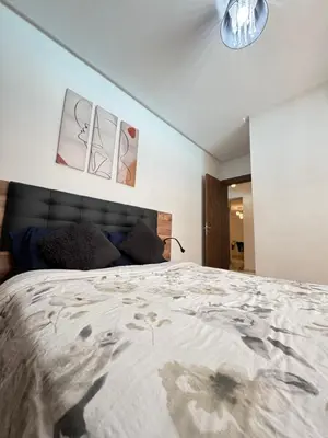 a bedroom with a large bed in a room at Appartement de luxe et moderne in Marrakech