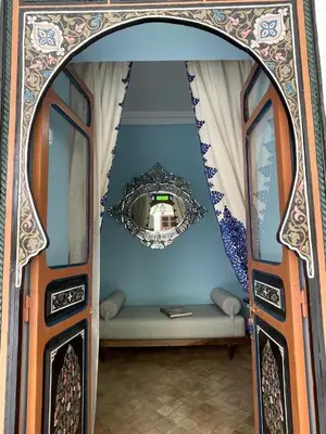 a view through an archway into a room with a mirror at Riad Ksar Al Amal & Spa in Marrakech