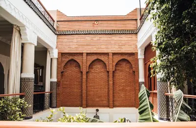 a brick building with arches on the side of it at Riad Ksar Al Amal & Spa in Marrakech