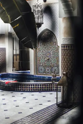 a room with a tub in a mosque with a tile wall at Riad Ksar Al Amal & Spa in Marrakech