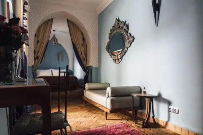 a living room with a couch and a mirror at Riad Ksar Al Amal & Spa in Marrakech