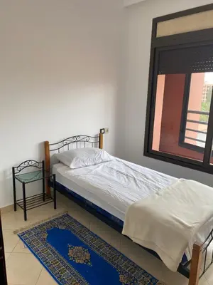 a bedroom with a bed and a mirror on the wall at Résidence Caprice Palace Hivernage in Marrakech