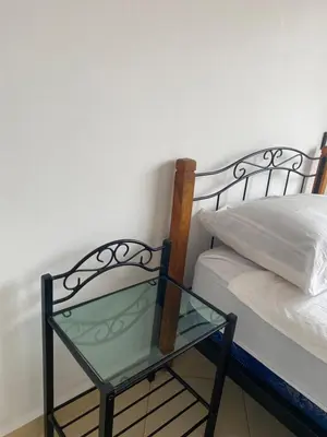 a glass table sitting next to a bed at Résidence Caprice Palace Hivernage in Marrakech