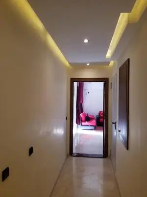 a hallway with a room with a red couch at Agréable appartement au coeur de Guéliz, Marrakech in Marrakech