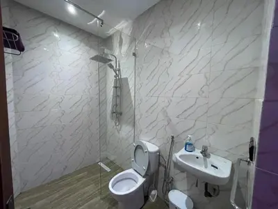 a white bathroom with a toilet and a sink at Dar El Azzouzi in Marrakech