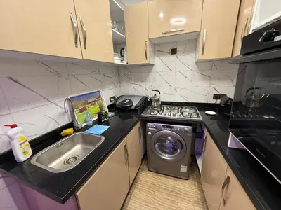 a kitchen with a sink and a washing machine at Dar El Azzouzi in Marrakech