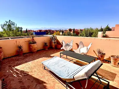 a patio with chairs and a table on a balcony at Al Maaden Ryad 69 a Marrakesh in Marrakech