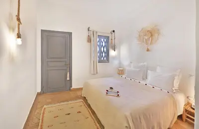 a bedroom with a large white bed with a window at Riad Amya & Spa in Marrakech
