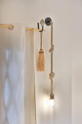 a bathroom with a broom and a curtain at Riad Amya & Spa in Marrakech