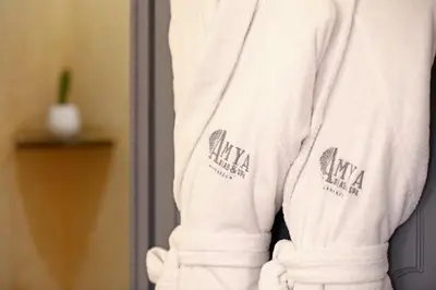 a white sweatshirt with two logos on the sleeve at Riad Amya & Spa in Marrakech