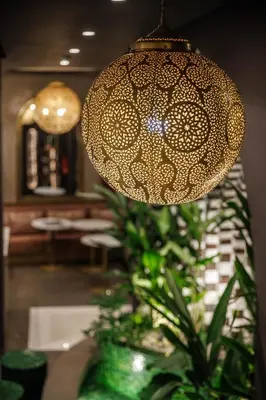 a chandelier with a lamp and a plant at Riad Nyla Wellness and Spa in Marrakech