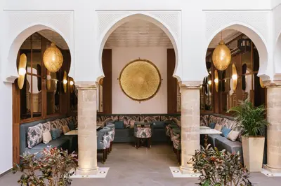 a lobby of a restaurant with couches and tables at Riad Nyla Wellness and Spa in Marrakech