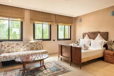 a living room with a bed and a couch at Villa près de golfs in Marrakech