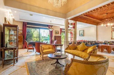 a living room with a couch and a table at Villa près de golfs in Marrakech