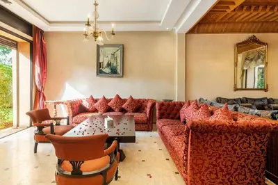 a living room with couches and a table at Villa près de golfs in Marrakech