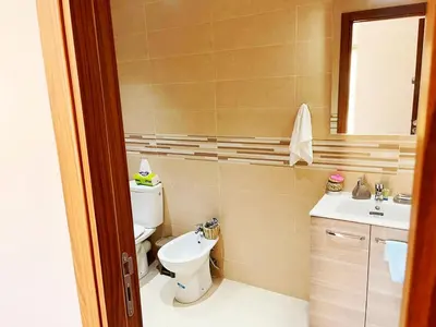 a bathroom with a toilet and a sink at Superbe appartement en résidence avec piscines in Marrakech