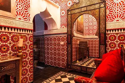 a bathroom with red and white tiles and a mirror at Palais El Roucar in Marrakech