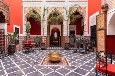 a courtyard with a large bowl in the middle of a building at Palais El Roucar in Marrakech