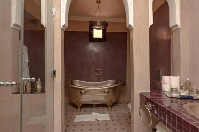 a bathroom with a tub and a sink at Palais El Roucar in Marrakech