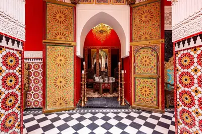 a room with red walls and red and gold doors at Palais El Roucar in Marrakech