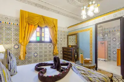 a living room with a bed and a mirror at Riad La Porte d'Or & SPA in Marrakech