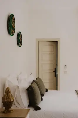 a bedroom with a bed with pillows on it at Riad Dar Blanche & Spa in Marrakech