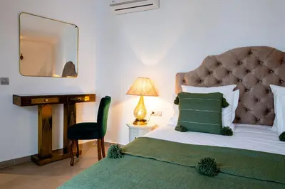 a bedroom with a bed and a mirror and a chair at Riad Dar Blanche & Spa in Marrakech