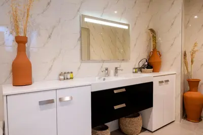 a white bathroom with a sink and a mirror at Riad Dar Blanche & Spa in Marrakech