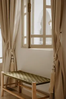a swing in front of a window with curtains at Riad Dar Blanche & Spa in Marrakech