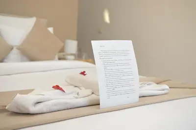 a tray with towels on a bed with a note at Villa Nour in Marrakech