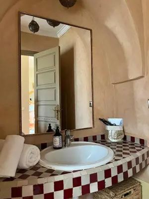 a bathroom with a sink and a mirror at Villa Nour in Marrakech