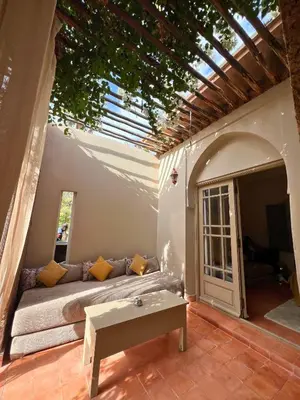 a patio with a couch and a table at Villa Nour in Marrakech