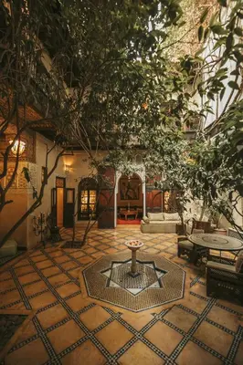 a courtyard with a fountain in the middle of a building at Riad Samsara in Marrakech