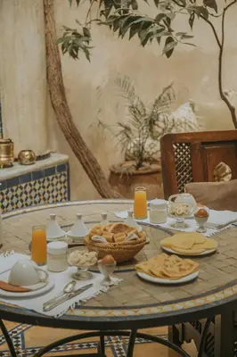 a table with plates of food on top of it at Riad Samsara in Marrakech