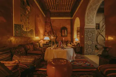 a living room with a table and couches at Riad Samsara in Marrakech