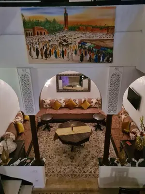 a model of a living room with a painting on the wall at Un Riad pour se divertir en famille & se détendre in Marrakech