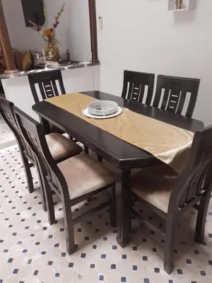 a dining room table with chairs and a table cloth on it at Un Riad pour se divertir en famille & se détendre in Marrakech
