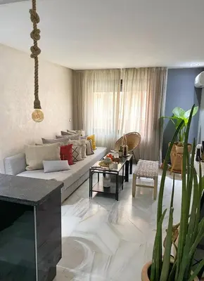 a living room with a couch and a table at Vitality Home in Marrakech