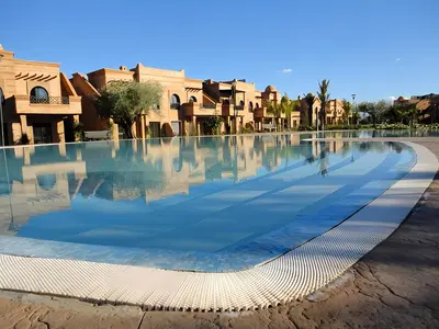a swimming pool in the middle of a city at Atlas Views By Golf Resort in Marrakech
