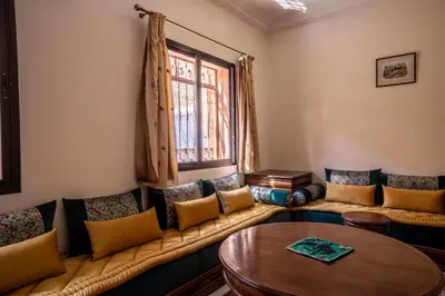 a living room with a couch and a table at Cosy Villa Sabah With Private Pool in Marrakech